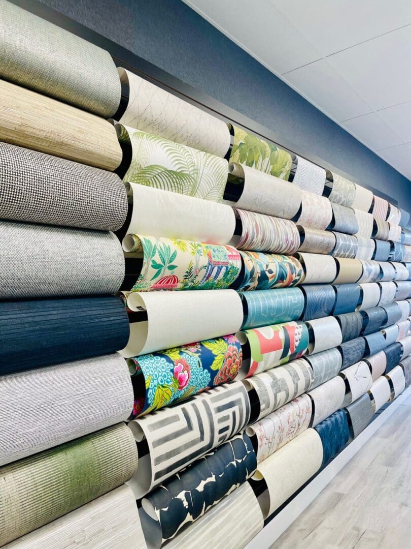 A wall of rolls of fabric in different colors.