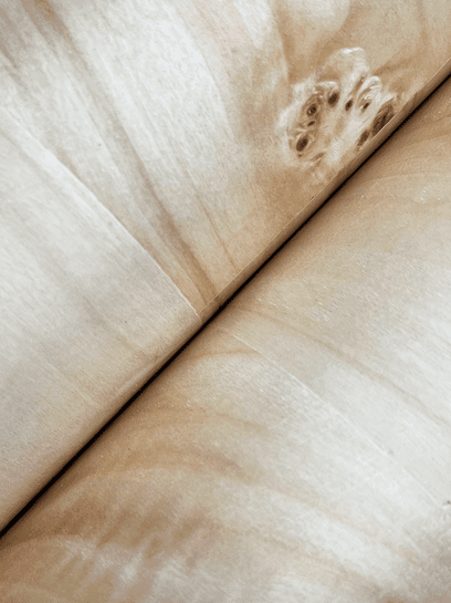 Light brown wood grain texture.