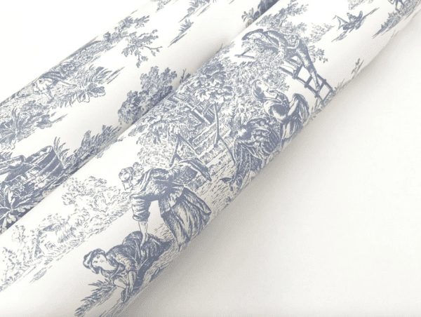 Blue toile fabric rolls, pastoral scene.