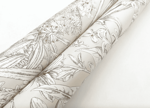 Floral wallpaper rolls, beige background.