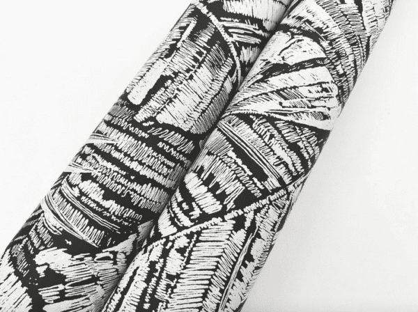 Black and white patterned fabric rolls.