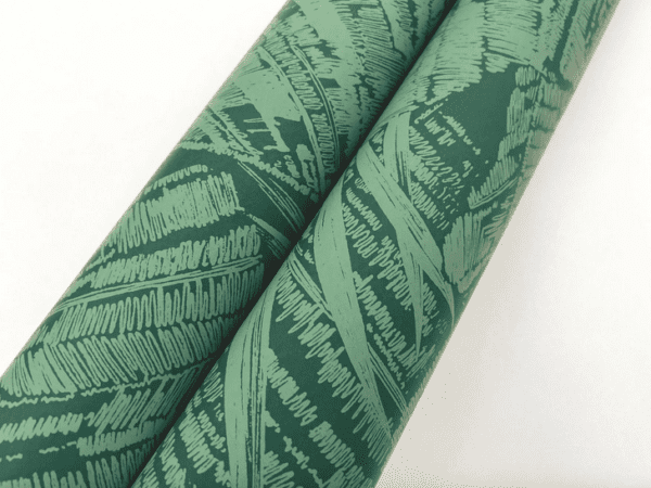 Green leaf patterned wrapping paper rolls.