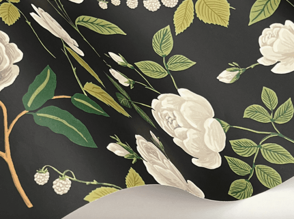 Black wallpaper with white roses and leaves.