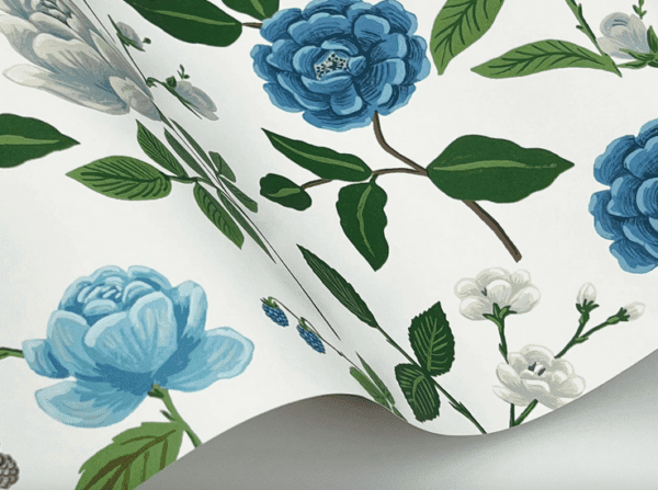 Blue floral wallpaper, green leaves.