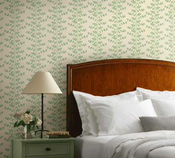 Green leaf wallpaper in bedroom setting.