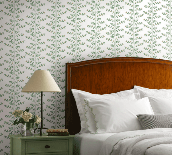 Green leaf wallpaper in bedroom setting.