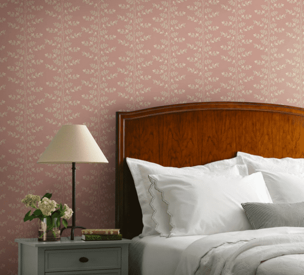 Pink floral wallpaper in bedroom setting.