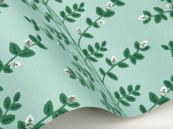 Green floral wallpaper with silver accents.