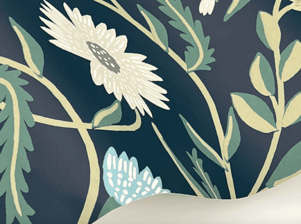 Navy floral wallpaper with white flowers.