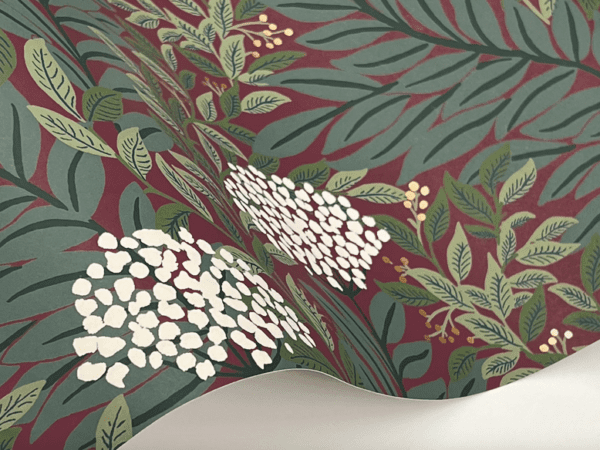 Red floral wallpaper with green leaves.