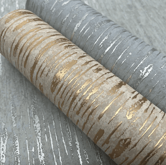 Gold and silver textured wallpaper rolls.