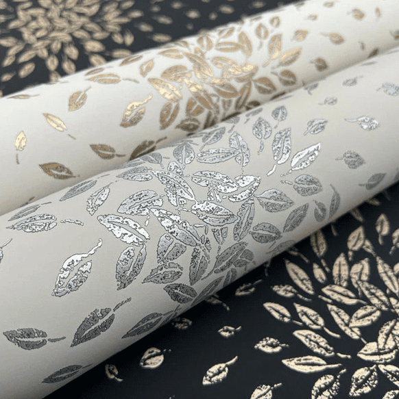 Metallic leaf wallpaper rolls.