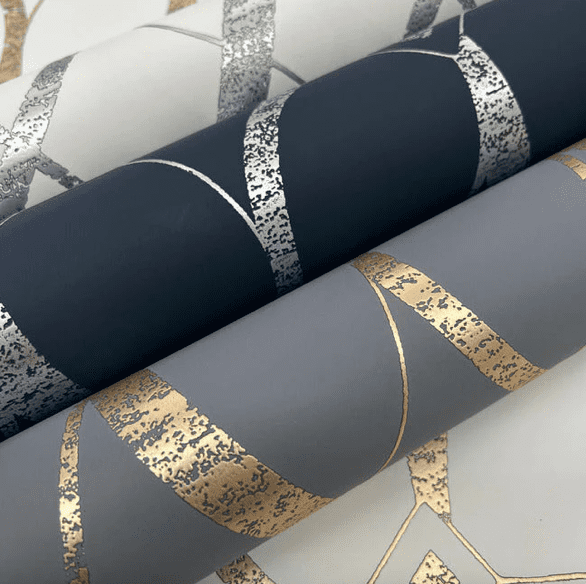 Gold and silver patterned wallpaper rolls.