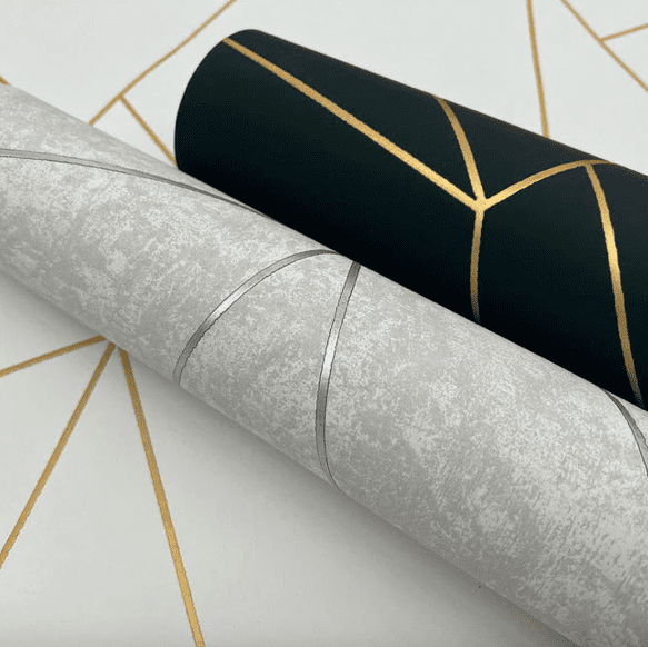 Grey and black geometric wallpaper rolls.